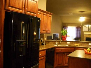 Updated kitchen with island, tile backsplash, quartz countertops in Preston Lakes III