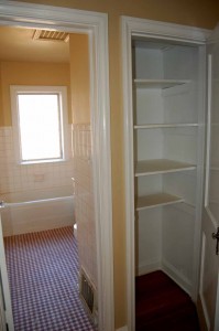 Hall bath with original tile and hall linen closet for storage
