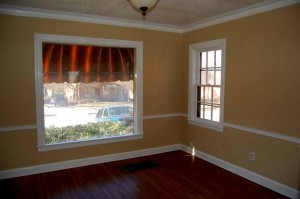 Separate formal dining with crown molding, chair railing, large window to front