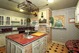 Kitchen with center island containing oven and cooktop