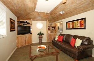 Den with vaulted ceiling and built-ins