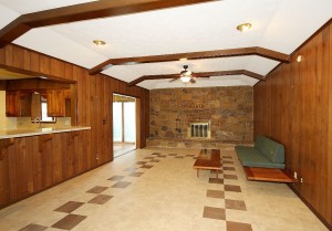 den toward fireplace wall